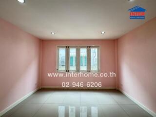 Empty room with pink walls and a window, suitable for various purposes
