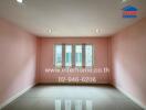 Empty room with pink walls and a window, suitable for various purposes