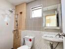 Modern bathroom with shower, toilet, sink and window
