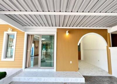 Front view of a modern building with covered porch and glass sliding doors