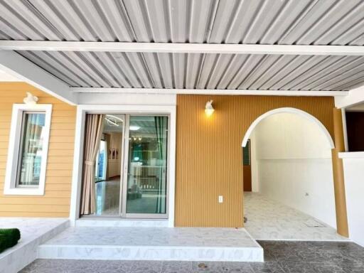 Front view of a modern building with covered porch and glass sliding doors