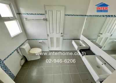 Bathroom with modern fixtures and a large mirror