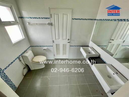 Bathroom with modern fixtures and a large mirror