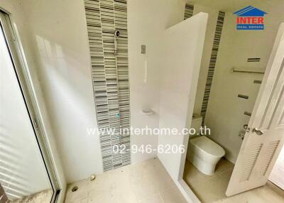 Bathroom with tiled walls and toilet