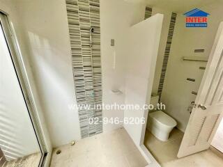 Bathroom with tiled walls and toilet