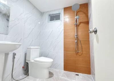 Modern bathroom with toilet, shower, and sink