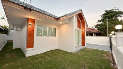 Exterior view of a modern single-story house with a lawn