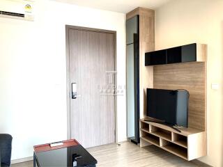 Modern living room with a wooden door and TV unit