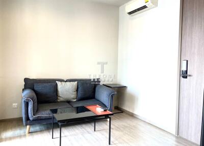 Minimalist living room with sofa, air conditioner, and coffee table