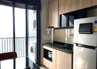 Modern kitchen with appliances and balcony view