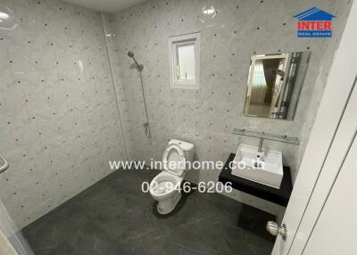 Clean bathroom with modern fixtures and tiled walls