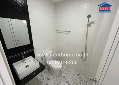 Modern bathroom with white tiles and a shower head