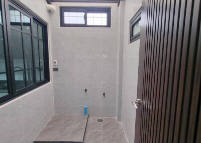Modern bathroom with tiled walls and windows