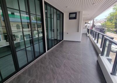 Spacious balcony with tiled flooring and glass doors