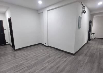 Empty hallway with wooden flooring