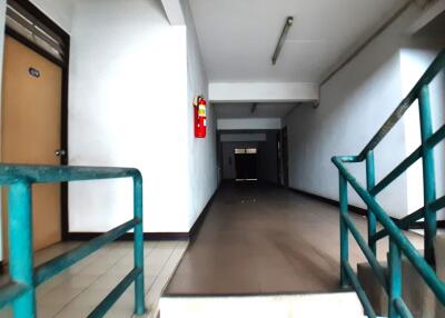 Building hallway with staircase and fire extinguisher