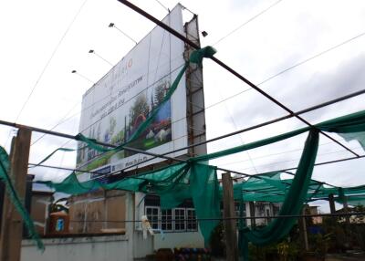 Commercial building under construction with a large billboard