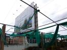 Commercial building under construction with a large billboard