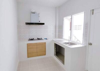 Modern kitchen with stove, sink, and cabinets