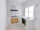 Modern kitchen with stove, sink, and cabinets