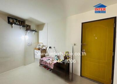 Hallway with bright yellow door and shelves