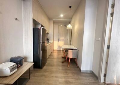 Modern, narrow kitchen with dining area