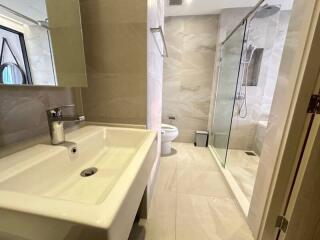 Modern bathroom with walk-in shower and white vanity