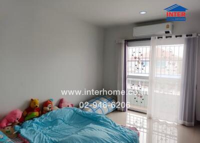 Bedroom with bed, stuffed toys, window, and air conditioning unit