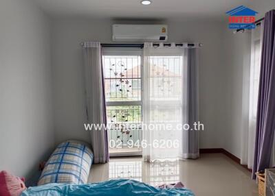 Bright bedroom with window and air conditioner