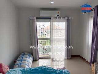 Bright bedroom with window and air conditioner