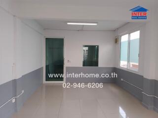 Empty room with tiled floor and glass door