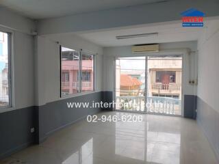 Spacious living room with large windows and AC unit