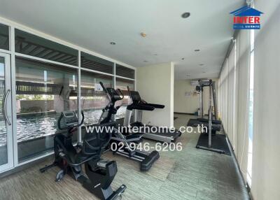 Property gym with exercise equipment and large windows