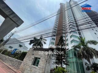 High-rise building exterior with palm trees