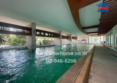Indoor swimming pool with green water and modern architecture