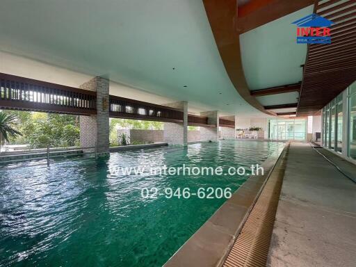 Indoor swimming pool with green water and modern architecture