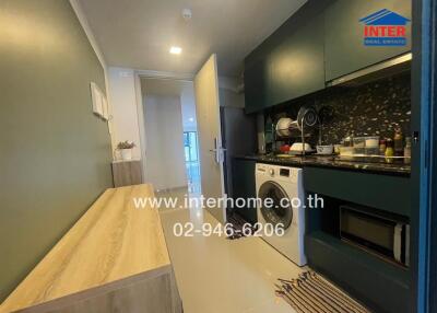 Modern kitchen with washer and built-in appliances