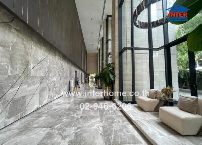 luxurious building lobby with large windows and modern decor