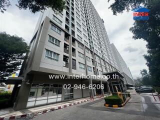 Modern high-rise residential building with trees in the foreground