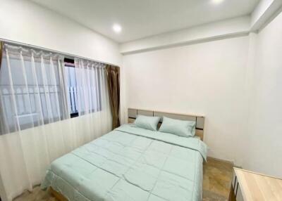 Spacious bedroom with a large bed and ample lighting