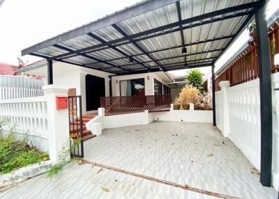 Outdoor covered parking area with gate