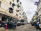 Apartment complex with multiple floors and parked motorbikes in front