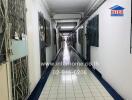 Long hallway in a building with secured doors and tiled floor