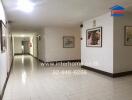 Hallway with artwork and a tiled floor