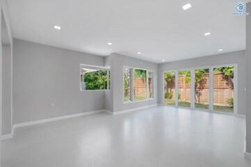 Spacious living room with large windows and modern lighting