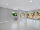 Spacious living room with large windows and modern lighting