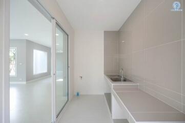 Modern kitchen with stainless steel sink and large sliding door