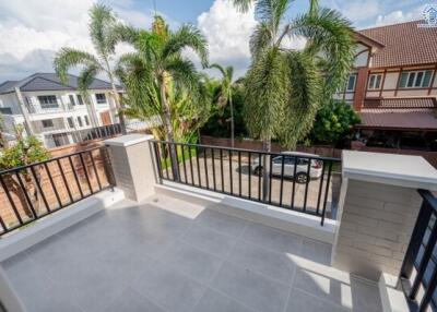 Balcony with railing, tiled floor, and view of neighborhood with houses and palm trees