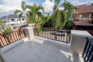 Balcony with railing, tiled floor, and view of neighborhood with houses and palm trees