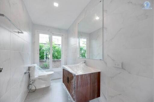 Modern bathroom with large mirror and window